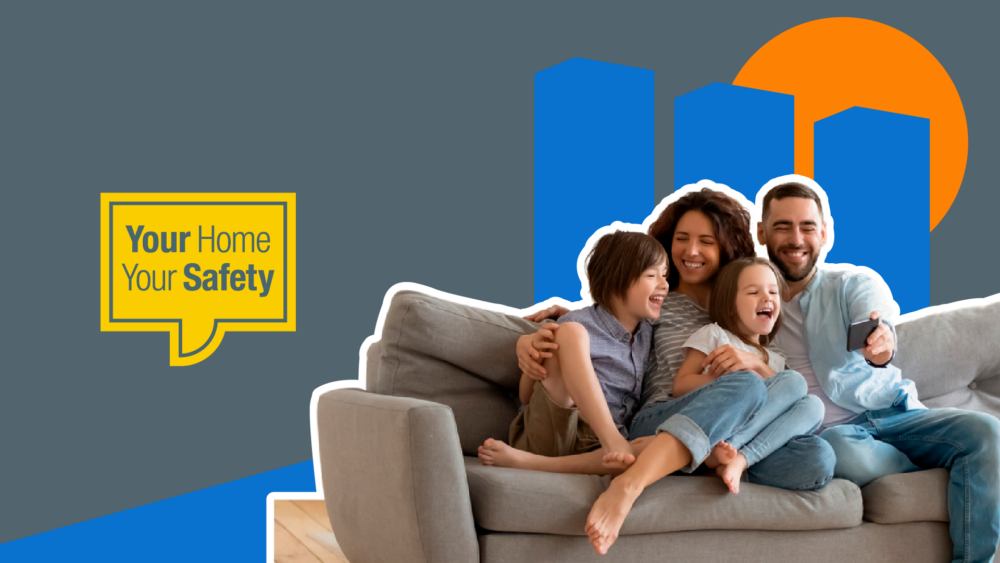 Family - two adults and two children, sat on a couch laughing as they look at a mobile phone. And a yellow speech bubble with Your Home Your Safety written in it.