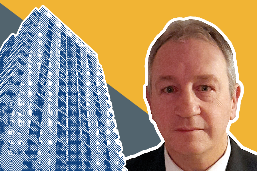 Ged Cooper in front of a blue high-rise building in a halftone pattern